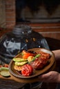 BBQ cooking concept, vegetables and meat sizzling on plate, chef presenting dish