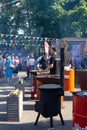 Russia, Moscow, 26-28th July 2019, BBQ festival in Moscow, Sokolniki park. Two male chefs in black caps and t-shirts cooking food