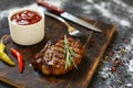 Bbq, Grilled beefsteaks, rosemary, wooden cutting board, dinner preparation, closeup. copy space, selective focus, Royalty Free Stock Photo