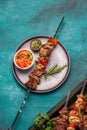 Bbq grilled meat pork and vegetable skewers on gray plate . Top view, flat lay Royalty Free Stock Photo