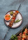 Bbq grilled meat pork and vegetable skewers on gray plate . Top view, flat lay, gray background Royalty Free Stock Photo