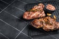 BBQ Grilled Pork loin steaks, neck meat. Black background. Top view. Copy space Royalty Free Stock Photo