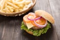 Bbq hamburger with french fries on the wooden background. Royalty Free Stock Photo