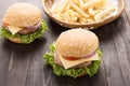 Bbq hamburger with french fries on the wooden background. Royalty Free Stock Photo