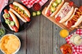 BBQ hot dog frame, overhead view table scene on a dark wood background Royalty Free Stock Photo
