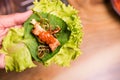 Grilling meat wrap green vegetable leaf for eat at restaurant