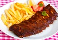 BBQ , marinated spareribs and french fries Royalty Free Stock Photo
