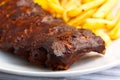 BBQ marinated spareribs and fries Royalty Free Stock Photo