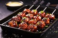 bbq meatball skewers on a black grilling pan