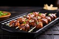 bbq meatball skewers on a black grilling pan