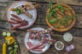 Bbq party fest Assortment various barbecue raw food meat, on plates wooden cutting board and grid on an old brown board