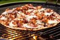 bbq pizza with melting mozzarella on a grill