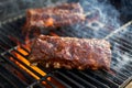 Bbq pork ribs cooking on flaming grill