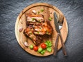 Bbq pork ribs grilled with tomatoes herbs and spices on wooden tray - Roasted barbecue pork spare rib sliced