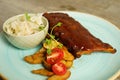 BBQ pork ribs with steak potatoes and cabbage salad Royalty Free Stock Photo