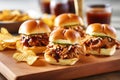 bbq pork sliders on mini artisan buns with a side of spicy chips