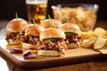 bbq pork sliders on mini artisan buns with a side of spicy chips