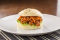Bbq pork vietnamese bao burger with pepper on white plate on wooden table