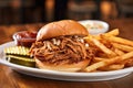 bbq pulled pork piled on a fresh bun, side pickle