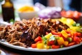 bbq pulled pork topped with colorful bell pepper slices Royalty Free Stock Photo