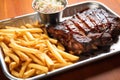 bbq ribs, fries, and coleslaw on a metal tray Royalty Free Stock Photo