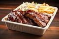 bbq ribs with fries and coleslaw in a takeout box Royalty Free Stock Photo