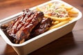 bbq ribs with fries and coleslaw in a takeout box Royalty Free Stock Photo