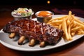 bbq ribs garnished with green onions, served with fries and coleslaw Royalty Free Stock Photo