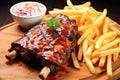 bbq ribs lathered in spicy sauce beside golden fries and coleslaw Royalty Free Stock Photo