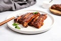 bbq ribs on a minimalist white plate with a silver fork and knife Royalty Free Stock Photo