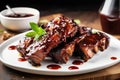 bbq ribs with tangy sauce dripping onto white plate