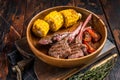 BBQ Roasted chops steaks of lamb, mutton in a wooden plate. Dark wooden background. Top view Royalty Free Stock Photo