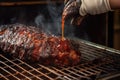 bbq sauce being brushed onto ribs in a smoker Royalty Free Stock Photo