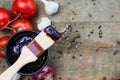 BBQ Sauce in a Bowl with Brush over a Wood Background with Ingredients Royalty Free Stock Photo