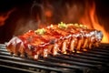 BBQ smoked ribs with dark background. Juicy dripping grilled ribs with smoke and fire.
