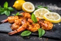 bbq spiced shrimps on a stone slab with lemon wedges Royalty Free Stock Photo