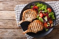 BBQ spicy pork cutlet with mixed salad on a plate close-up. horizontal top view Royalty Free Stock Photo