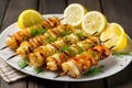 bbq squid skewers on a plate with lemon slices