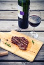 BBQ steak. Barbecue grilled beef steak meat with red wine Royalty Free Stock Photo