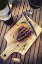 BBQ steak. Barbecue grilled beef steak meat with red wine and kn Royalty Free Stock Photo