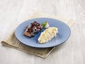 BBQ and steamed pork and chicken Combination Served in a dish isolated on wooden board side view on grey background