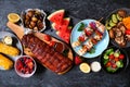 BBQ or summer picnic food table scene over a dark stone background