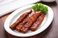 bbq tempeh ribs placed on a white plate Royalty Free Stock Photo