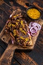 BBQ Texas Sandwich with slow roasted brisket beef meat. Dark wooden background. Top view