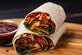 bbq veggie wrap with a spicy red sauce smear