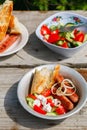 BBQ. Village lunch. grilled sausages with vegetable salad, onion and grilled bread. Royalty Free Stock Photo