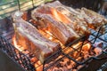 BBQpork ribs cooking on flaming grill shot