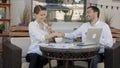 Bbusinessmen shaking hands in cafe