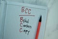 BCC - Blind Carbon Copy write on a book isolated on Wooden Table Royalty Free Stock Photo