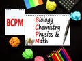 BCPM biology chemistry physics math symbol. Concept words BCPM biology chemistry physics math on the note on beautiful black Royalty Free Stock Photo